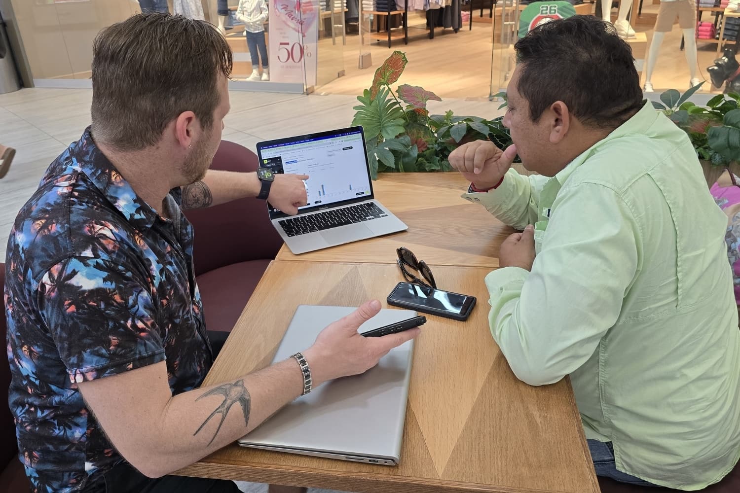 Francisco Pacheco and Kevin Carter reviewing local visibility data for a business in Mexico.